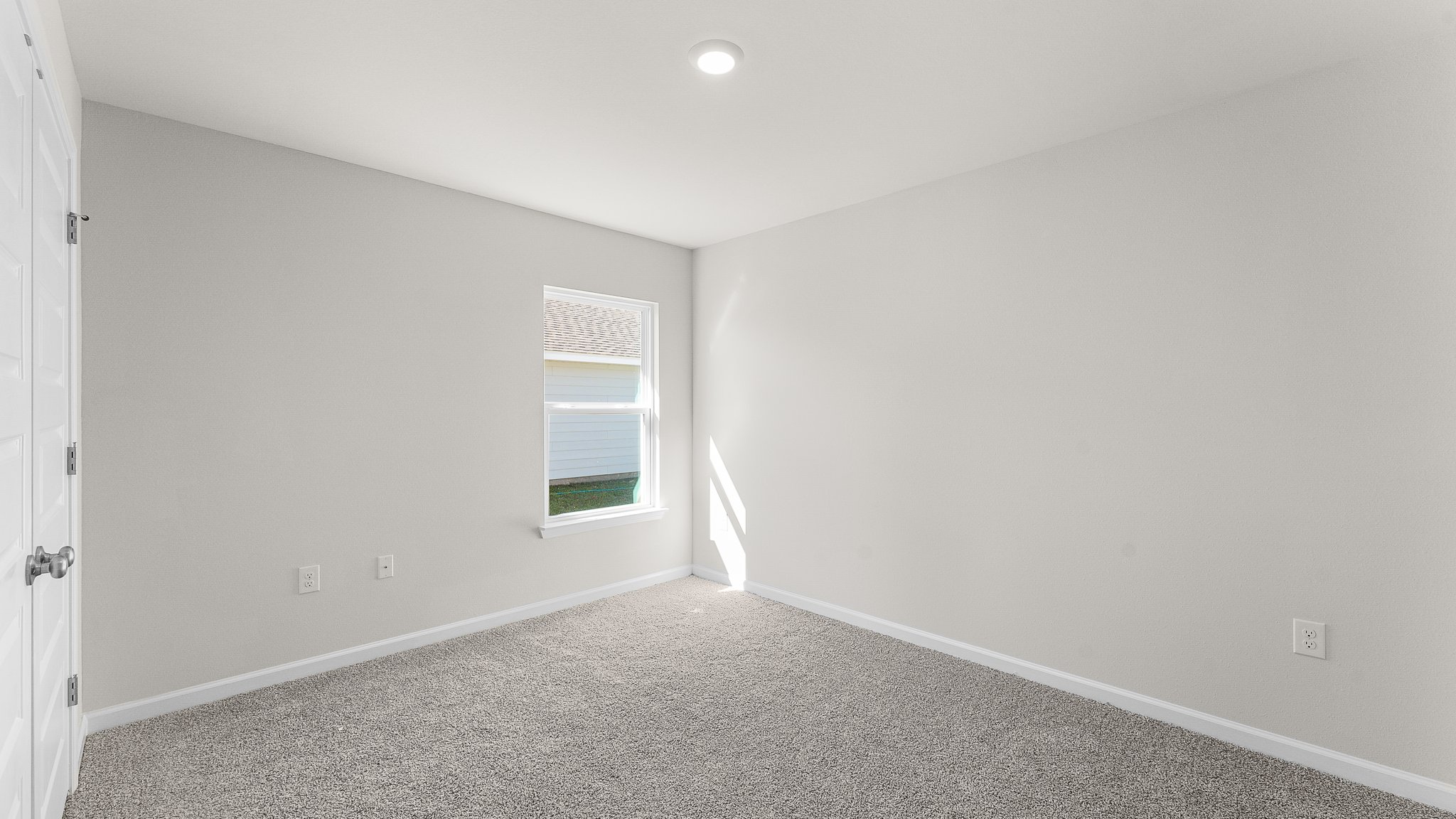 Bedroom with carpet floors and window.