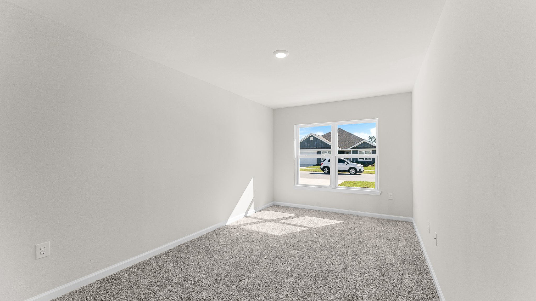Bedroom with carpet floors and window.