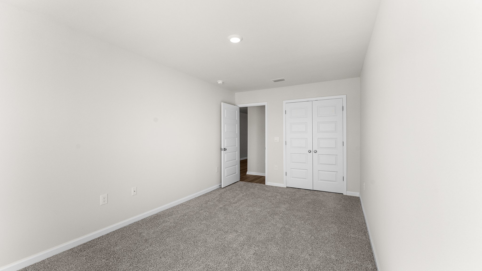 Bedroom with carpet floors and closet.