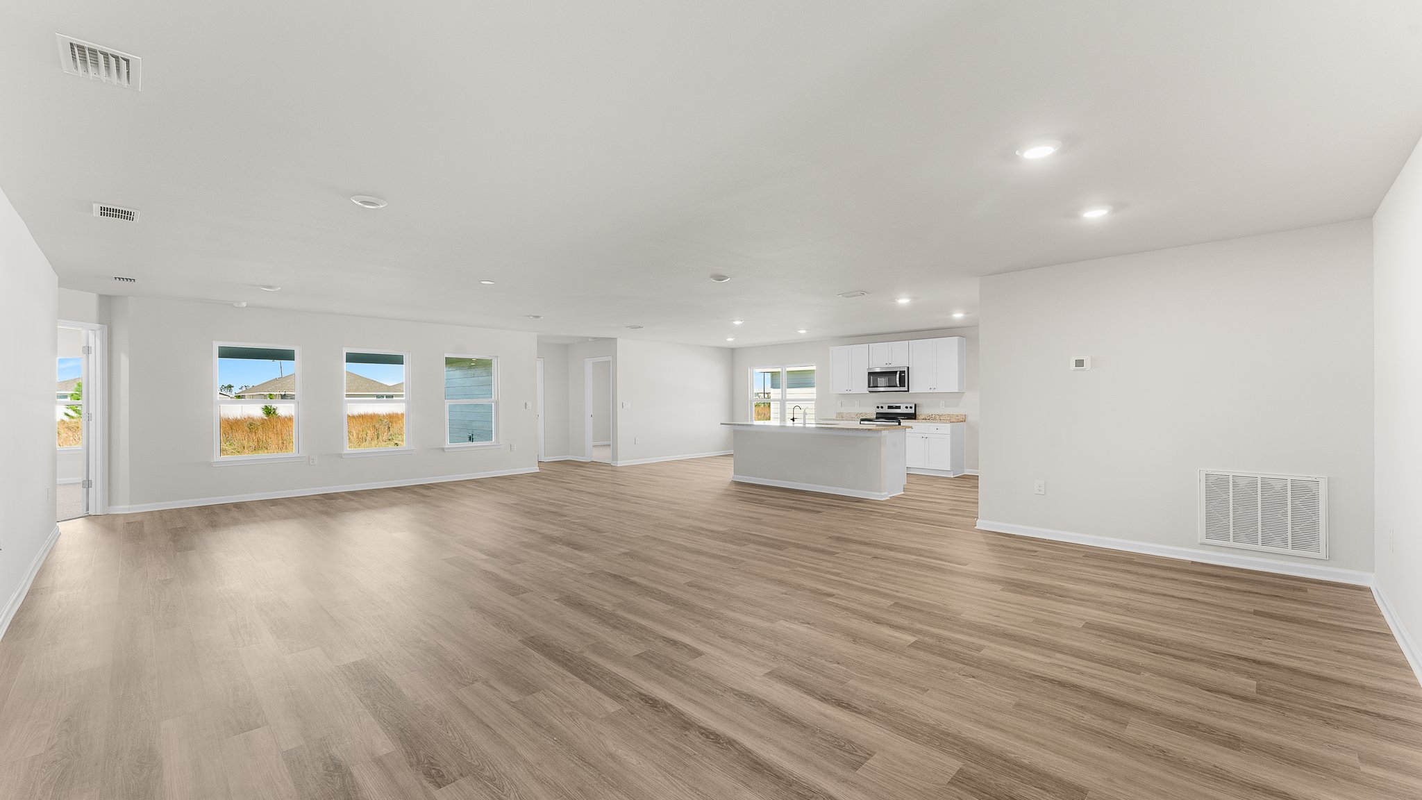 Open Living room with EVP flooring and dining area.