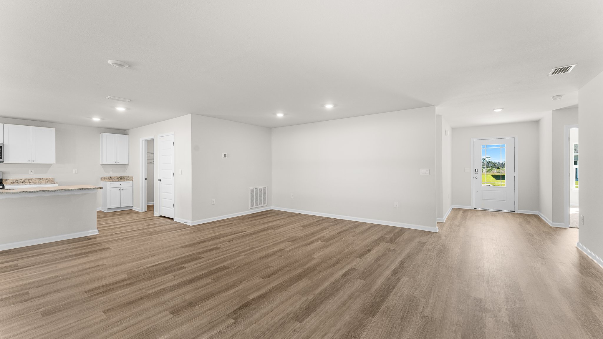 Open Living room with EVP flooring and dining area.