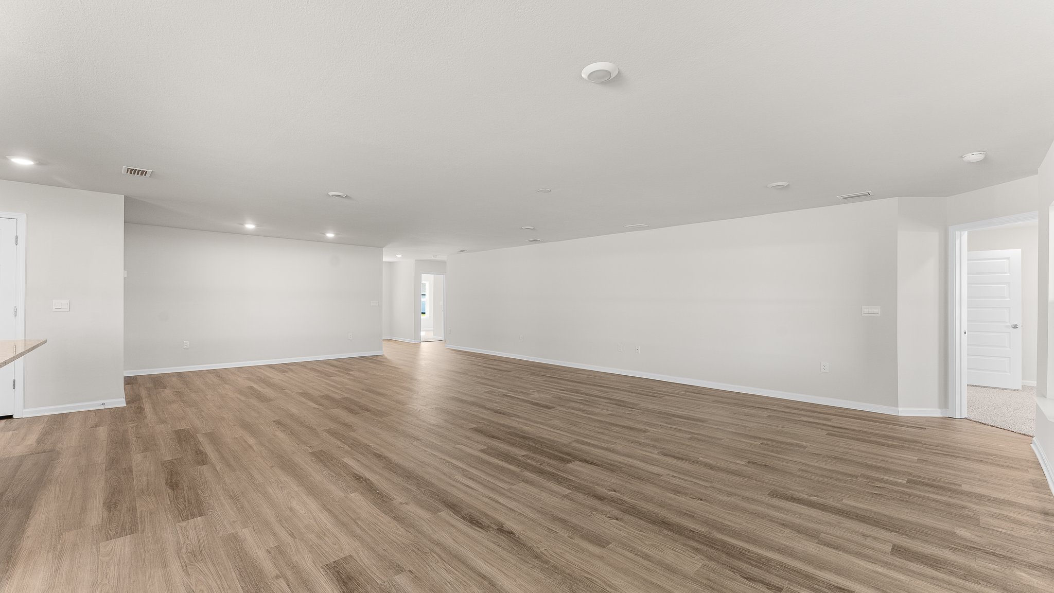 Open Living room with EVP flooring and dining area.