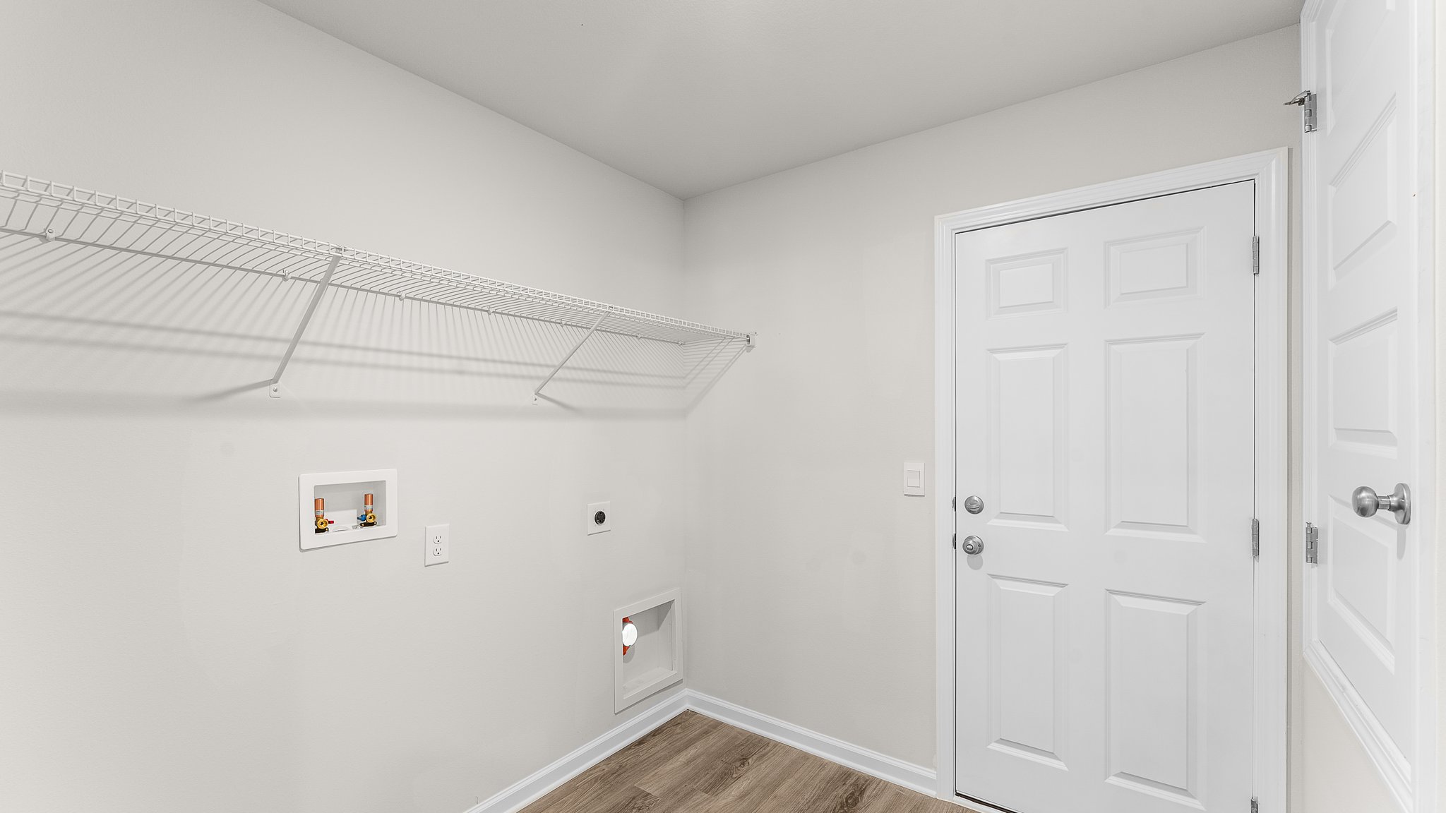 Laundry room with ventilated shelving.