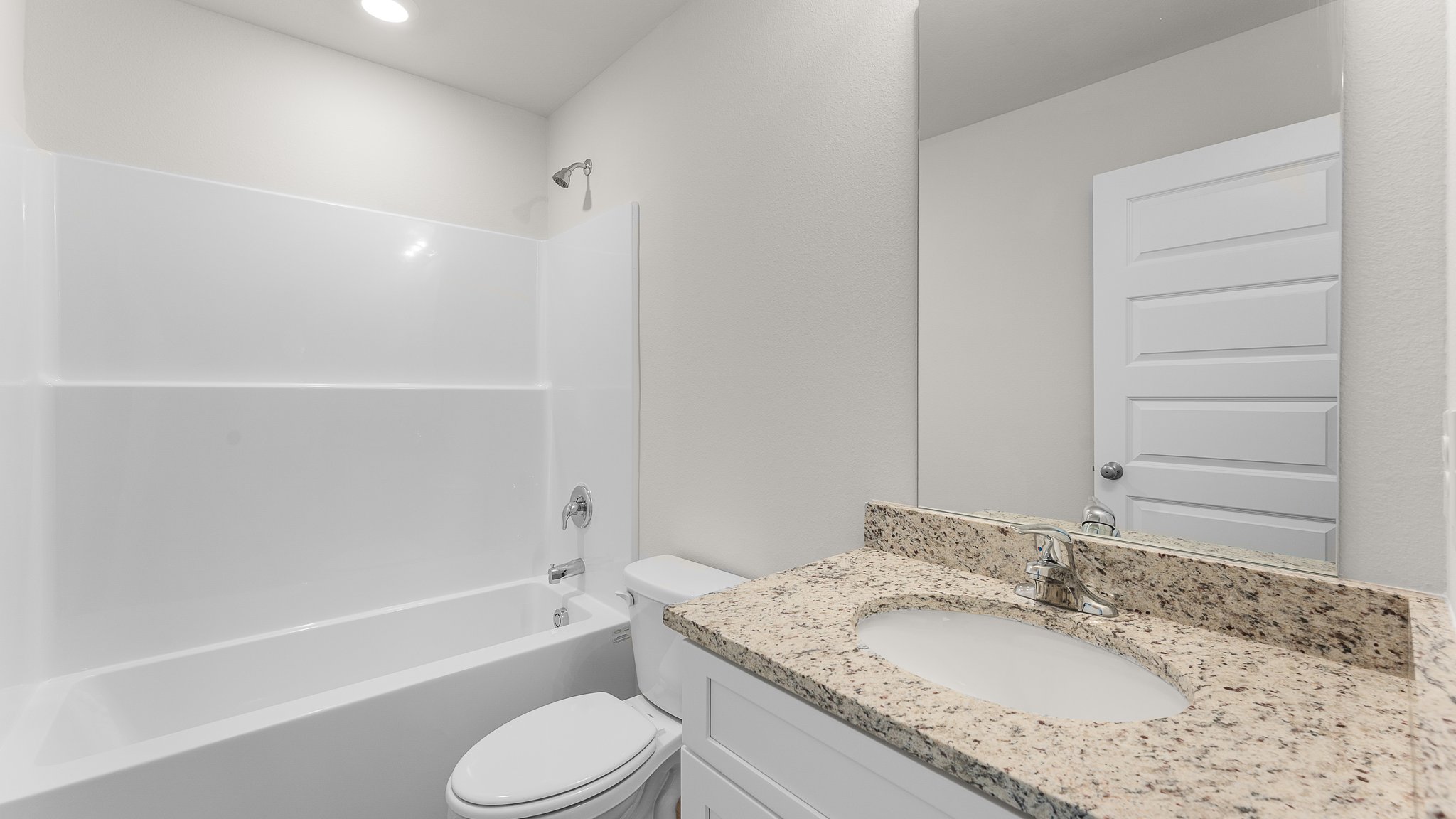 Bathroom with EVP flooring and white cabinets with granite countertop and single vanity and shower and toilet.