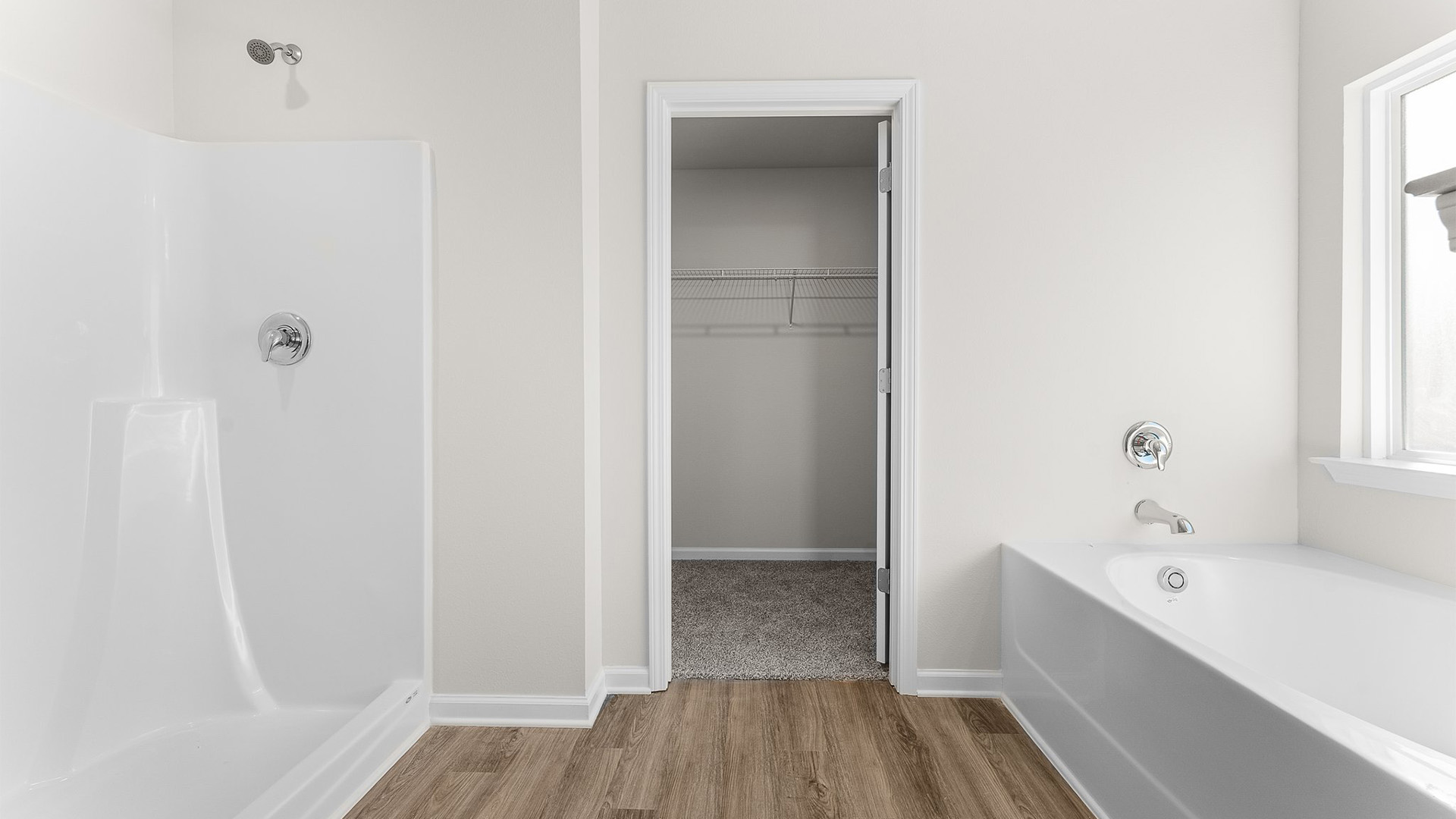 Primary bathroom tub and shower and walk-in closet.