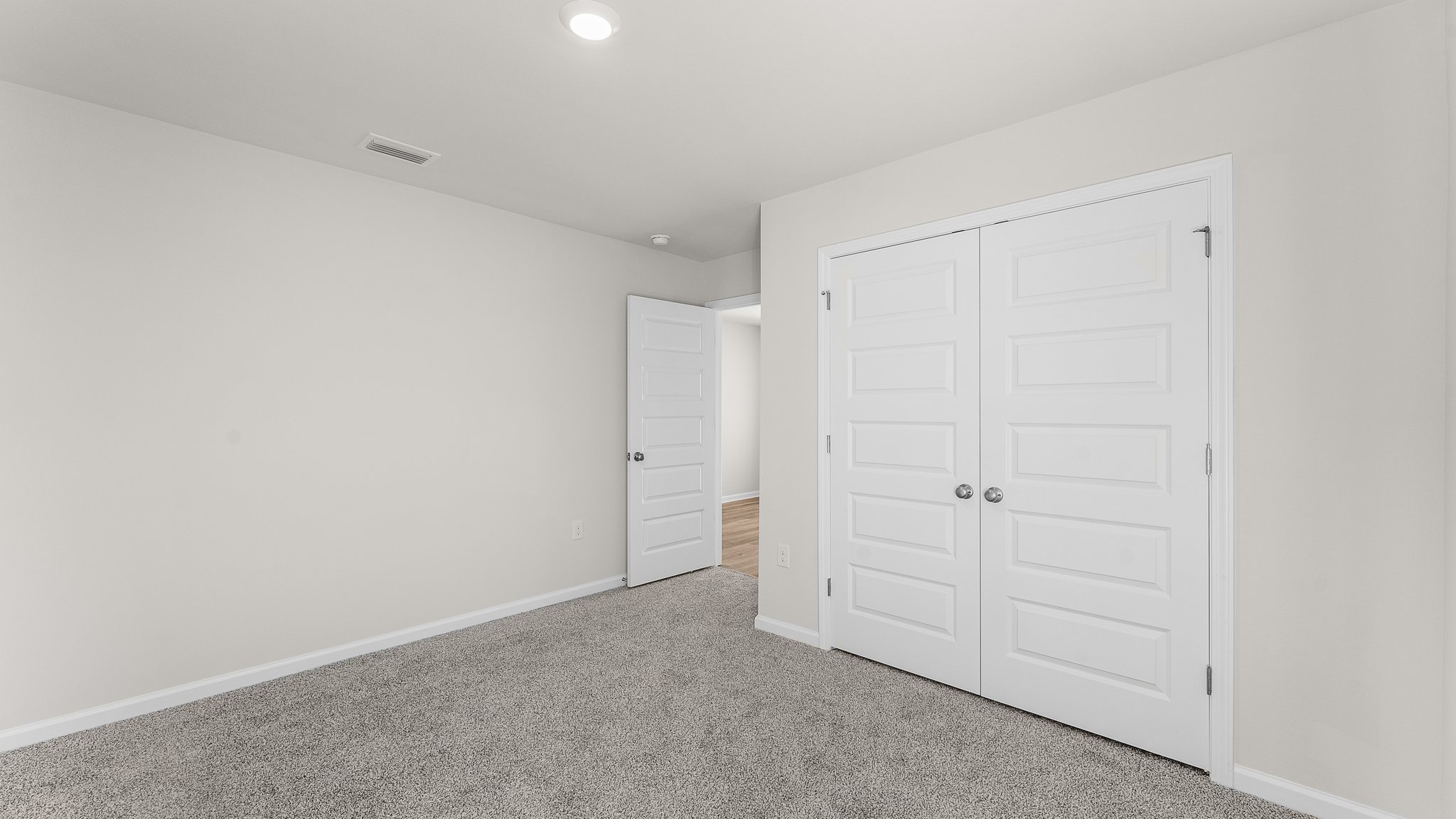 Bedroom with carpet floors and closet.