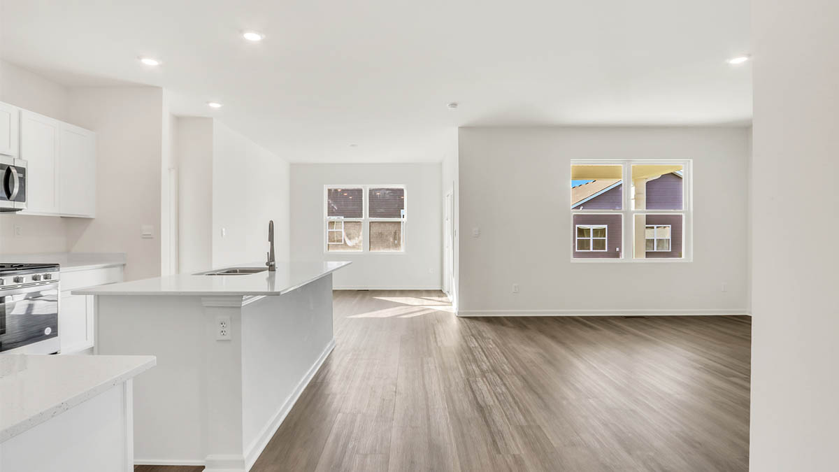 Open concept view of kitchen island and windows.