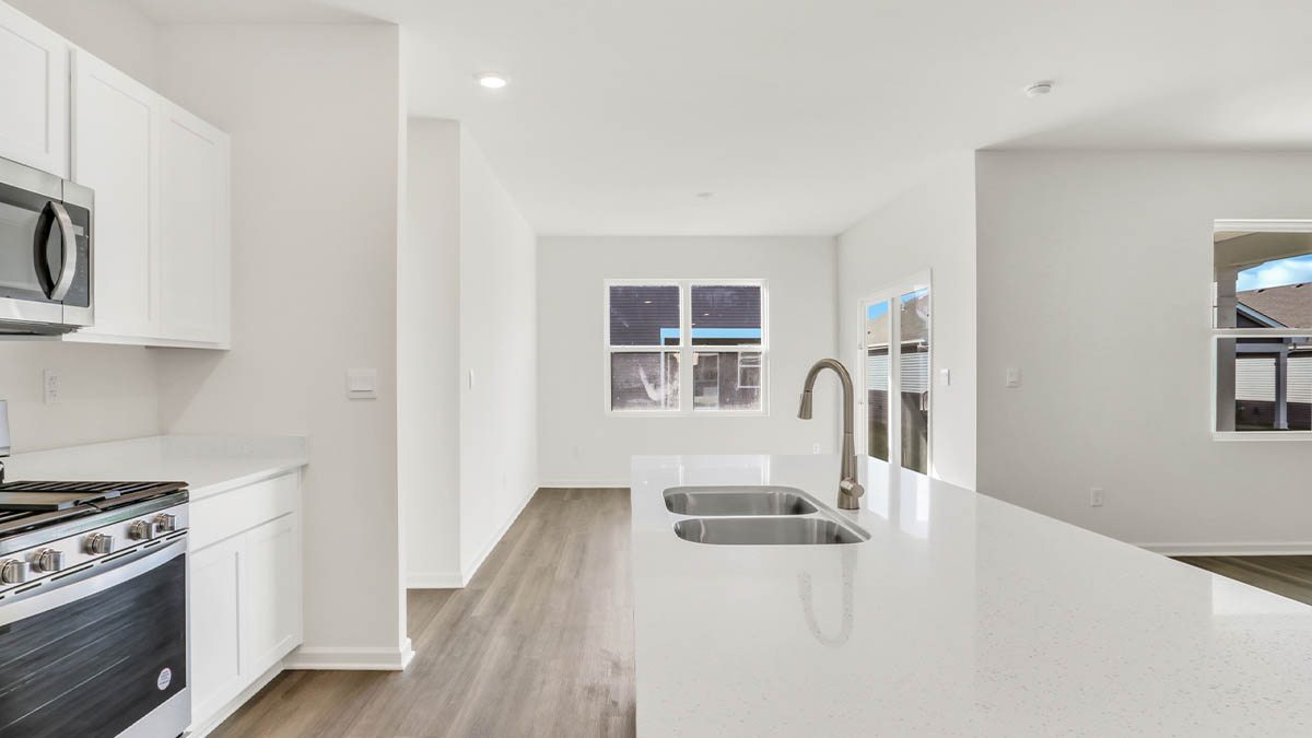 Kitchen island with view of dining area and window.