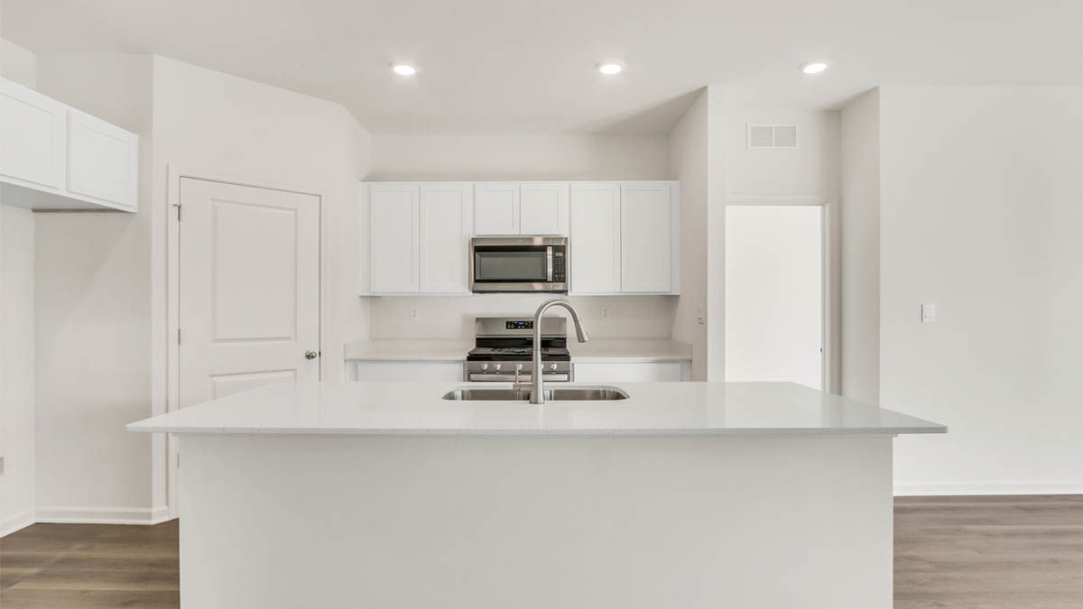 Kitchen with quartz countertops and island.