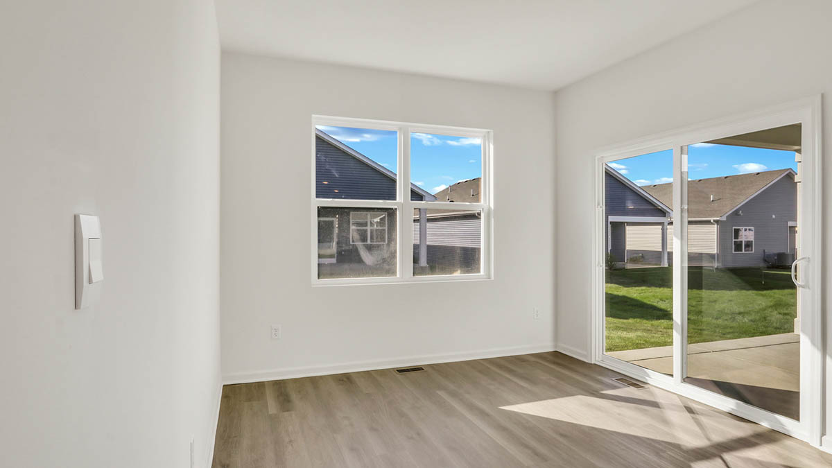 Dining room with window and sliding glass back door.