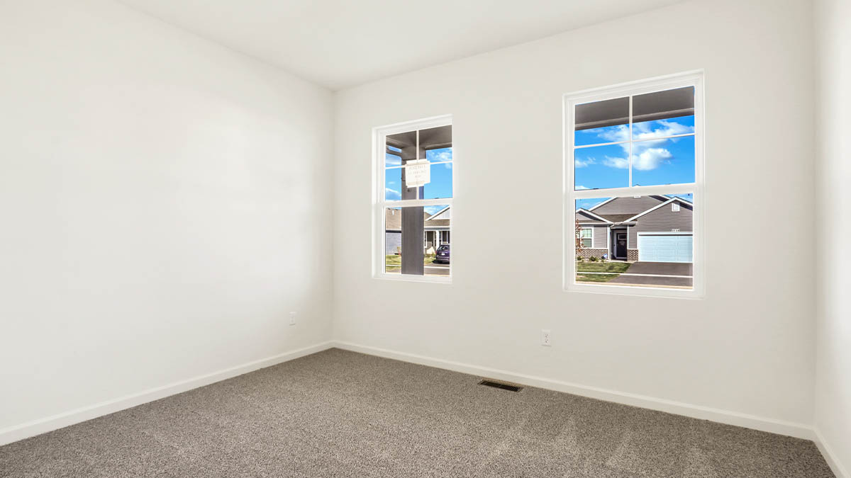 Room with windows and carpet.