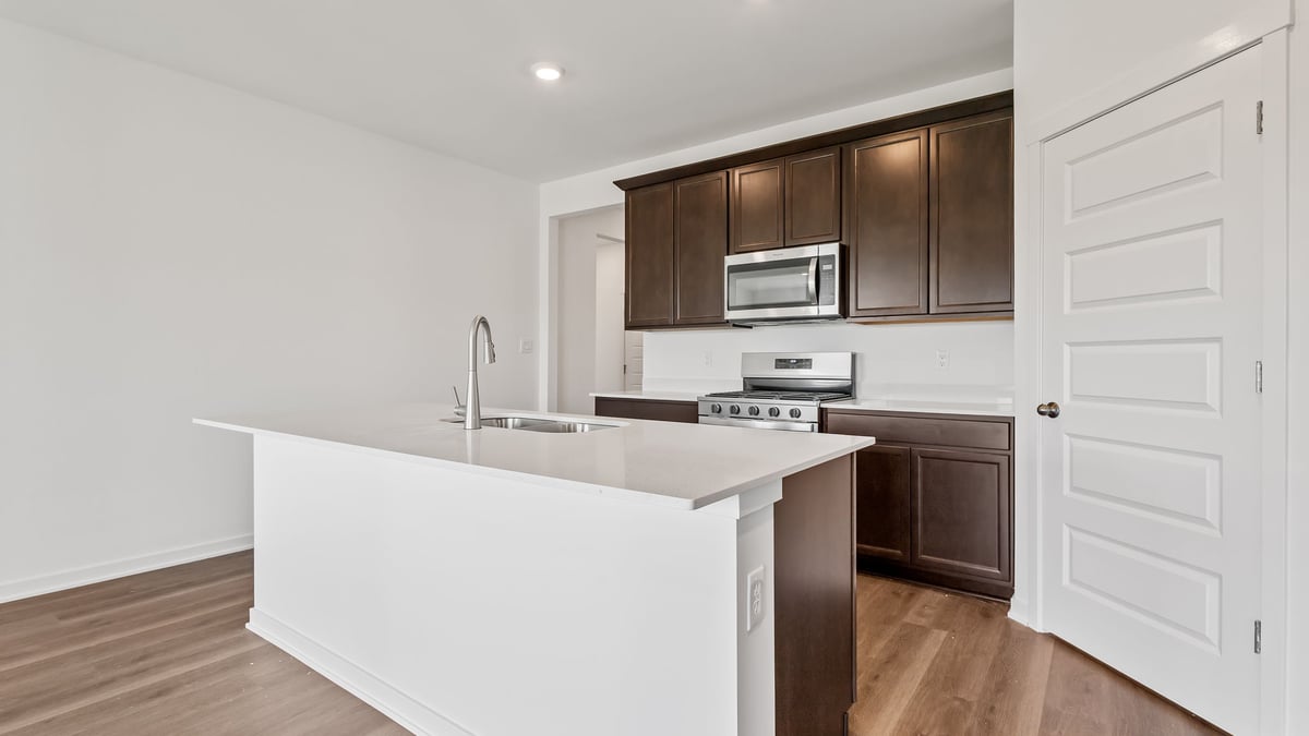 Kitchen with brown cabinets and a kitchen island.