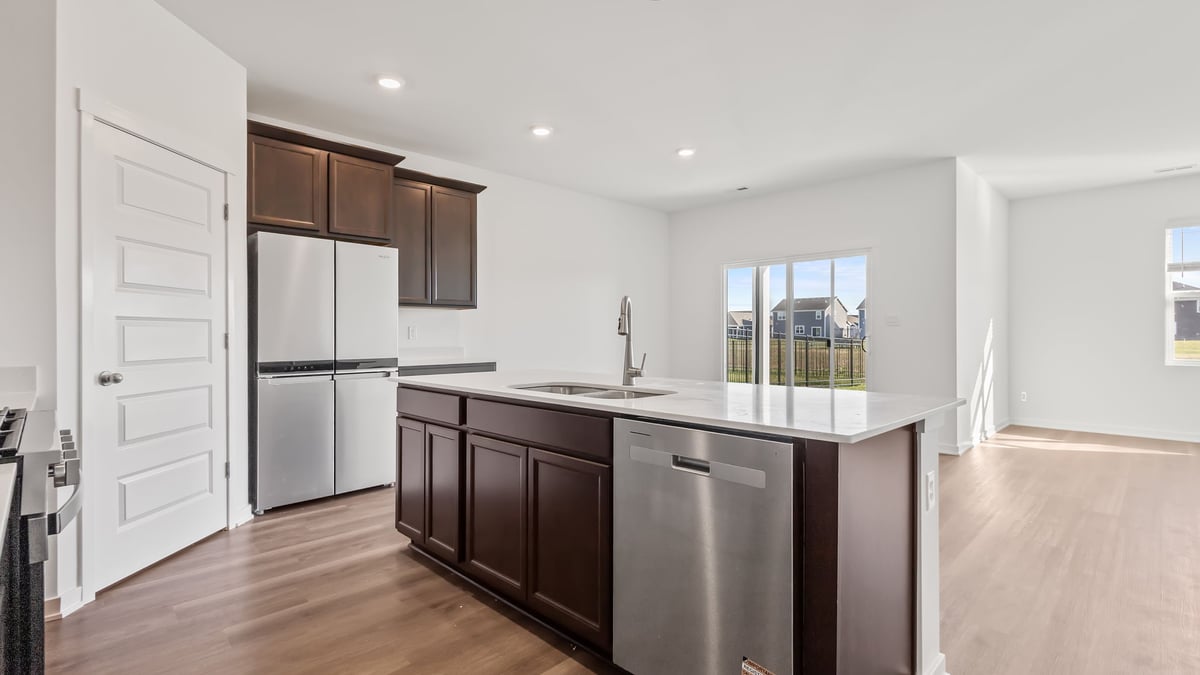 Kitchen island with brown cabinets overlooking the dining area.