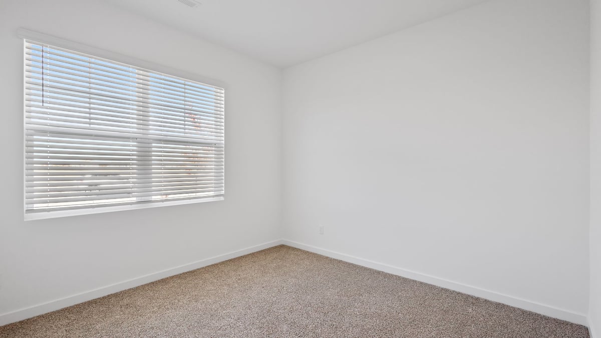 Bedroom with a window and carpet.