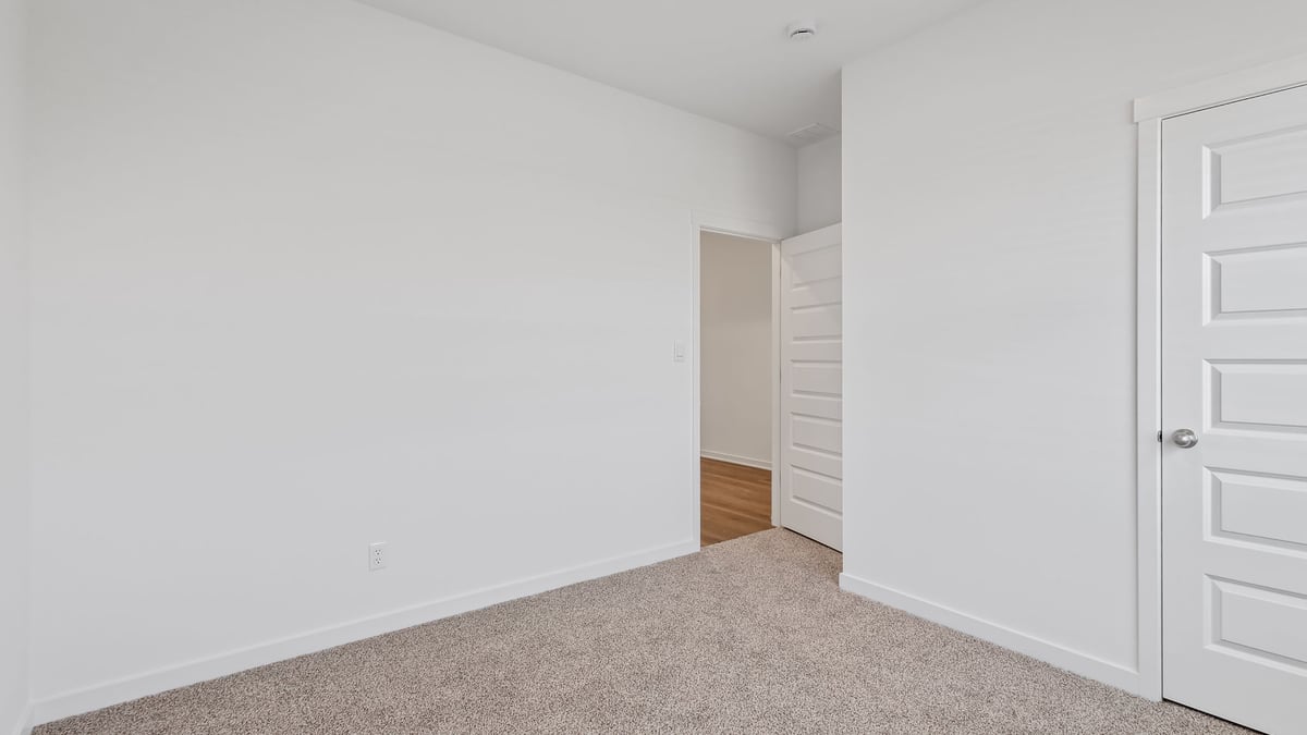 Bedroom with carpet and a closet.