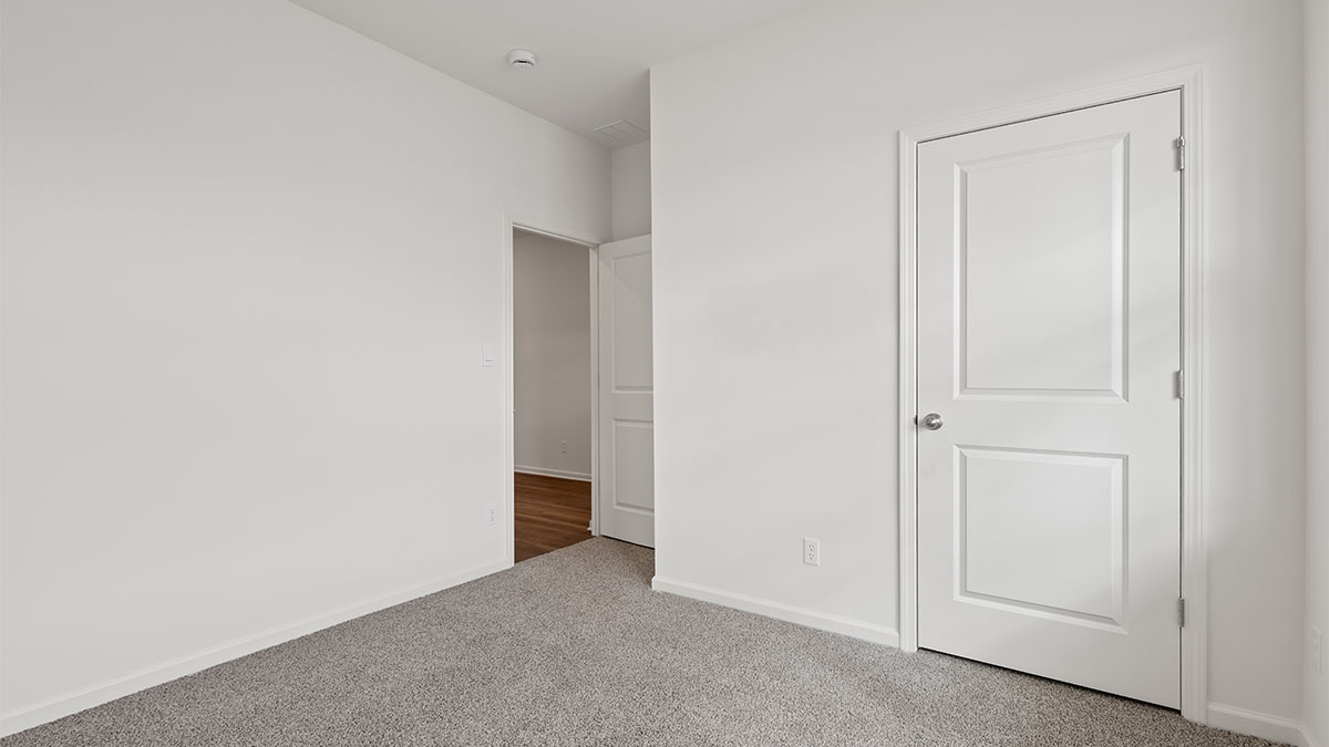 Bedroom with carpet and a closet.