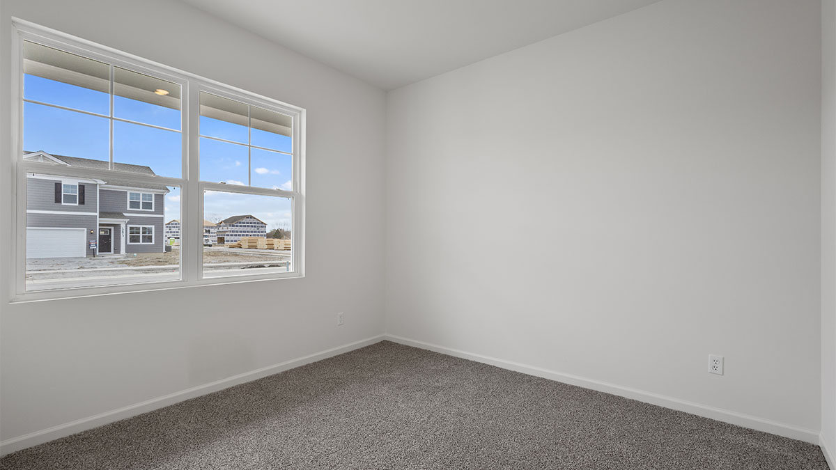 Bedroom with carpet and a big window.