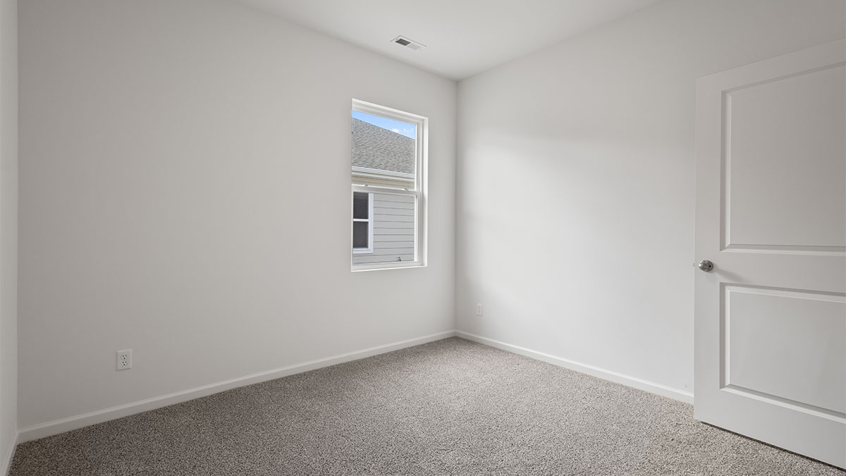 Bedroom with one window with a carpet.