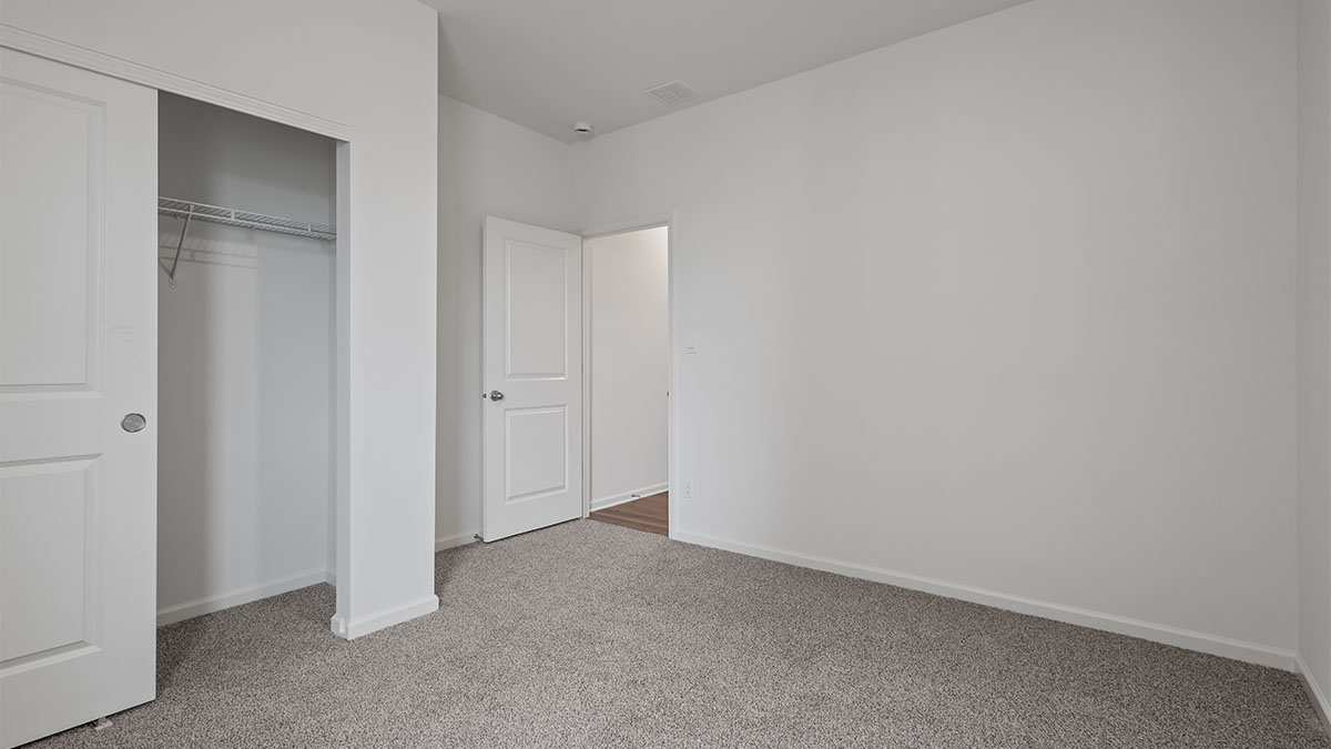 Bedroom with carpeted floors and a closet.