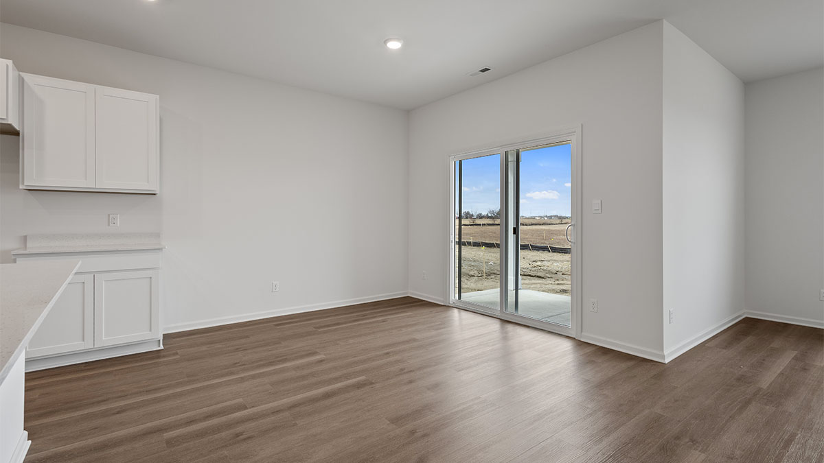 Dining area with hard wood floors with glass sliding doors.