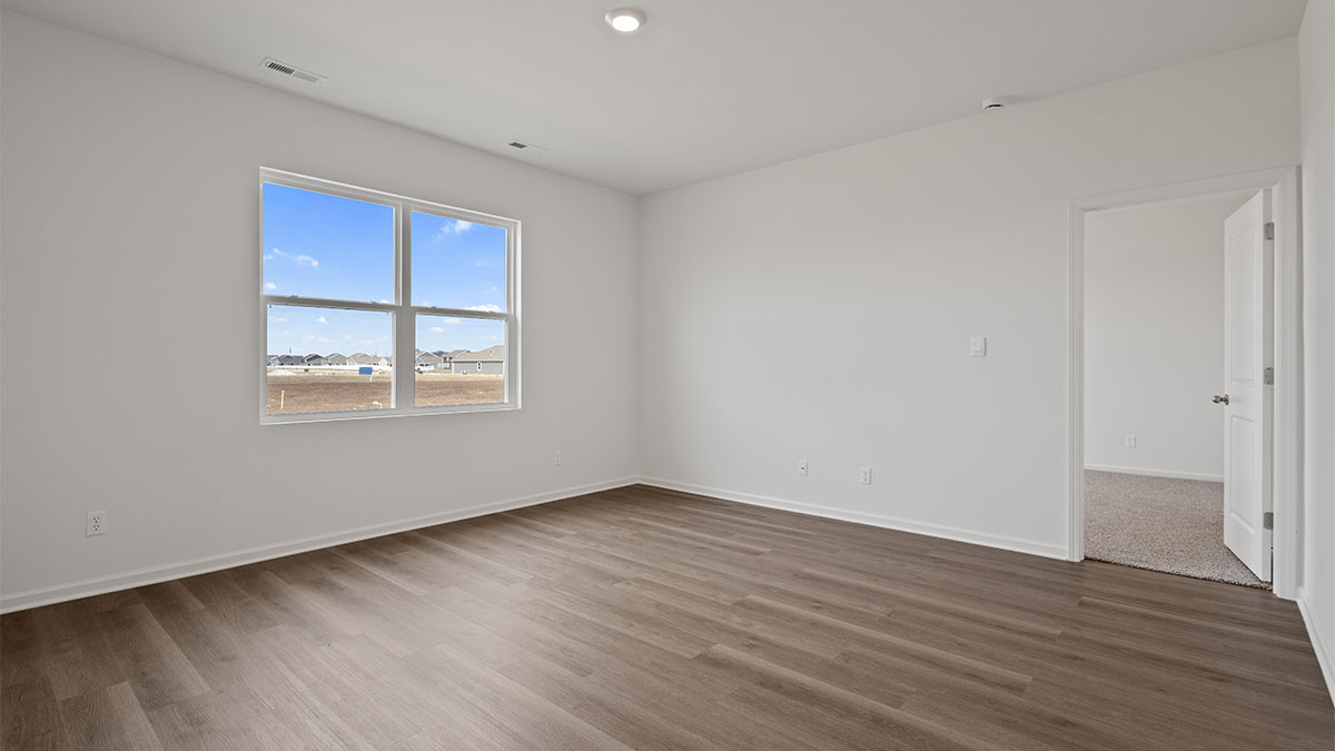 Living area wit hard wood floors and a big window.