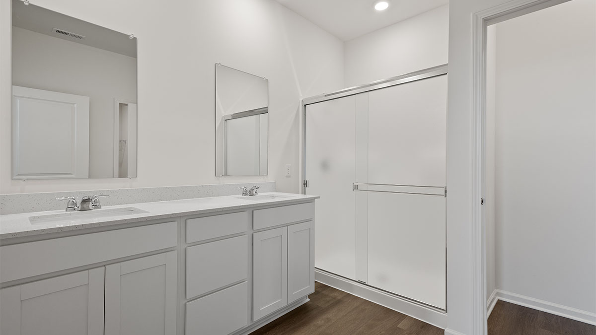 Dual vanity sinks with a walk-in shower.