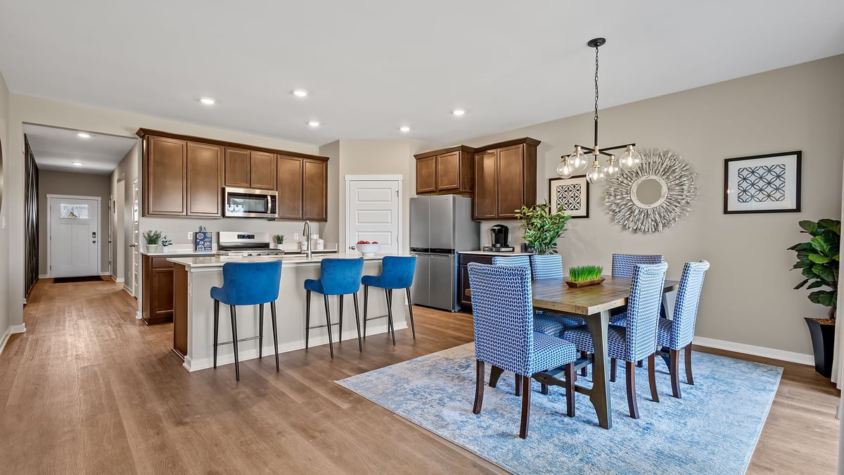 Dining and kitchen area with hard wood flooring and great amounts of space.