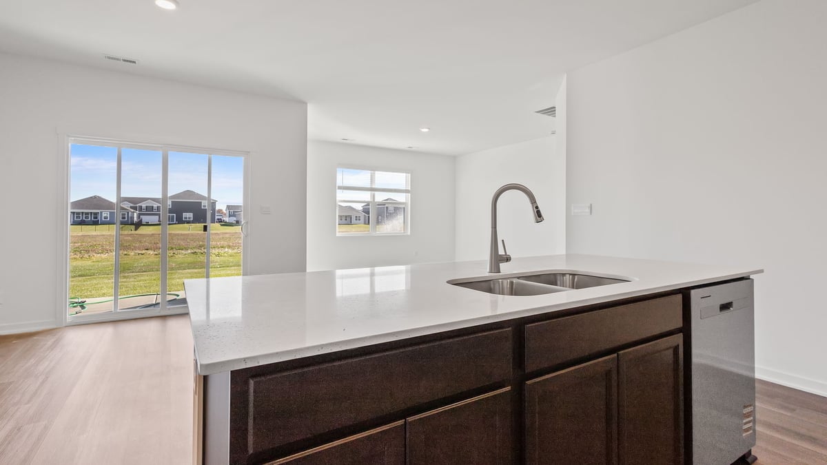 Kitchen island with quartz countertops and hard wood flooring.