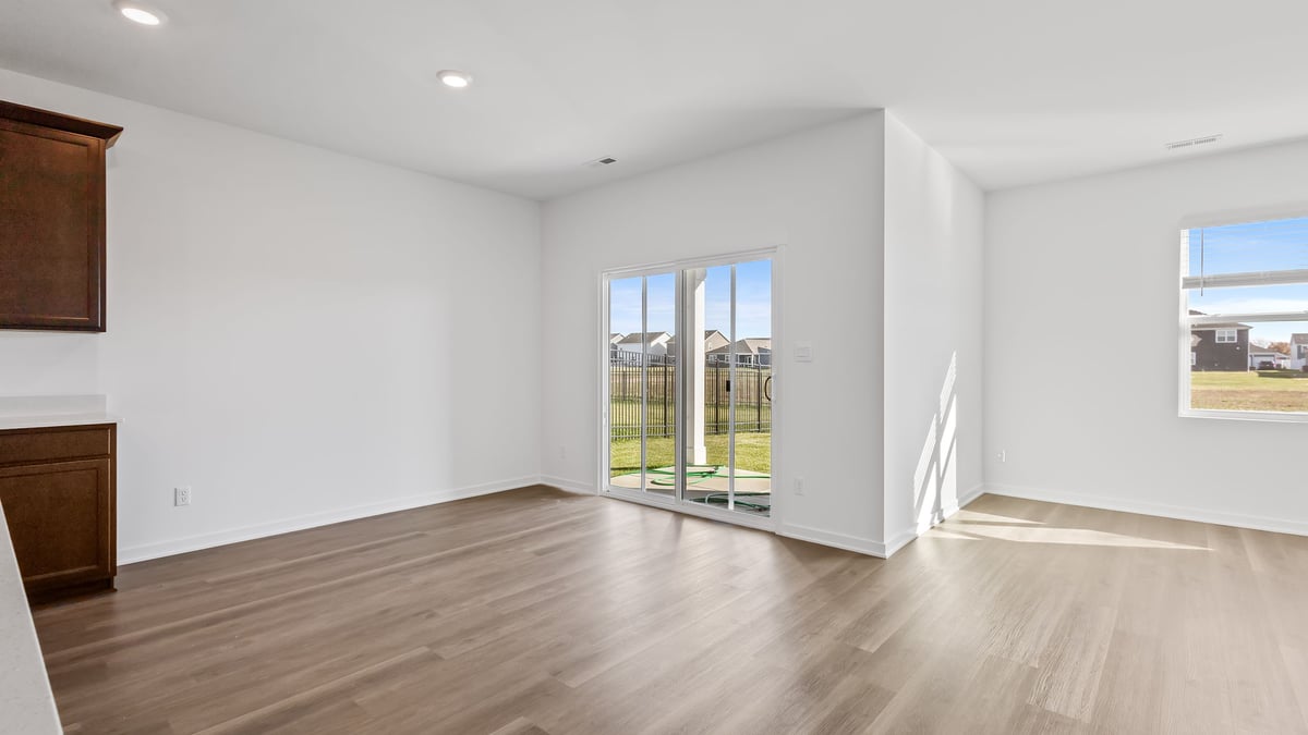 Dining area with hard wood flooring and glass sliding doors.