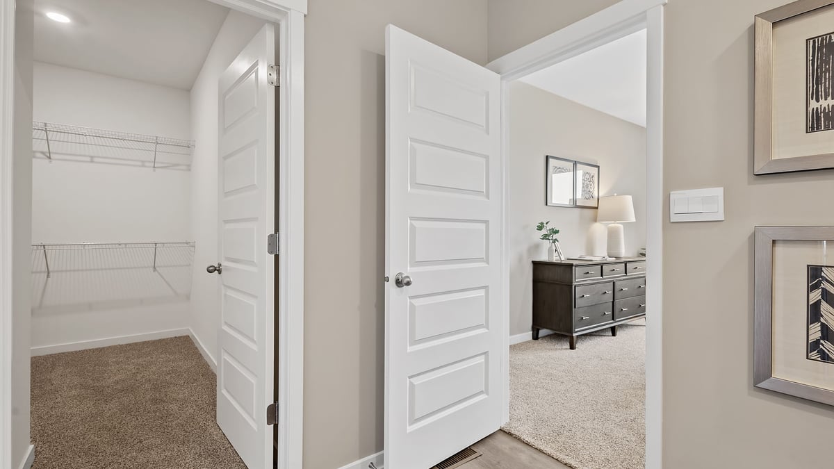 Walk-through area of primary bathroom and bedroom.