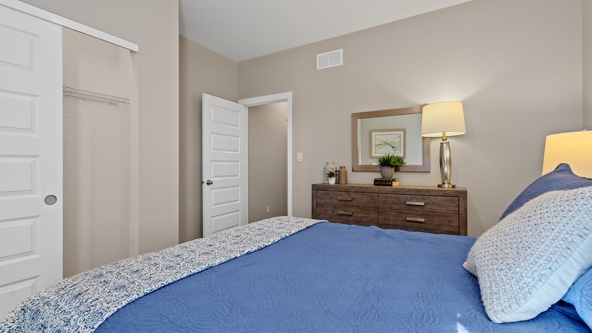 Bedroom with carpeted floors and a closet.
