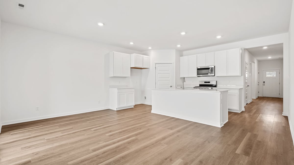 Kitchen and living room area with hard wood floors.