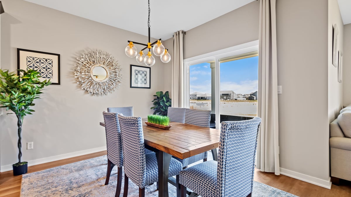 Dining area with a glass sliding door and hard wood floors.