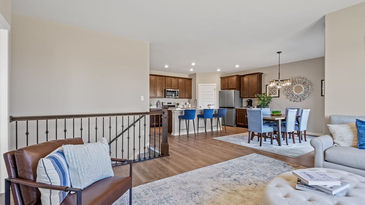 Living room area with hard wood floors and a open railing.