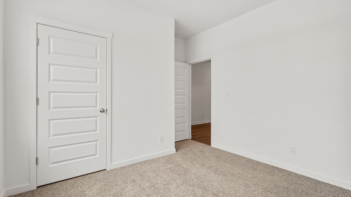 Bedroom with carpeted floors and a closet.