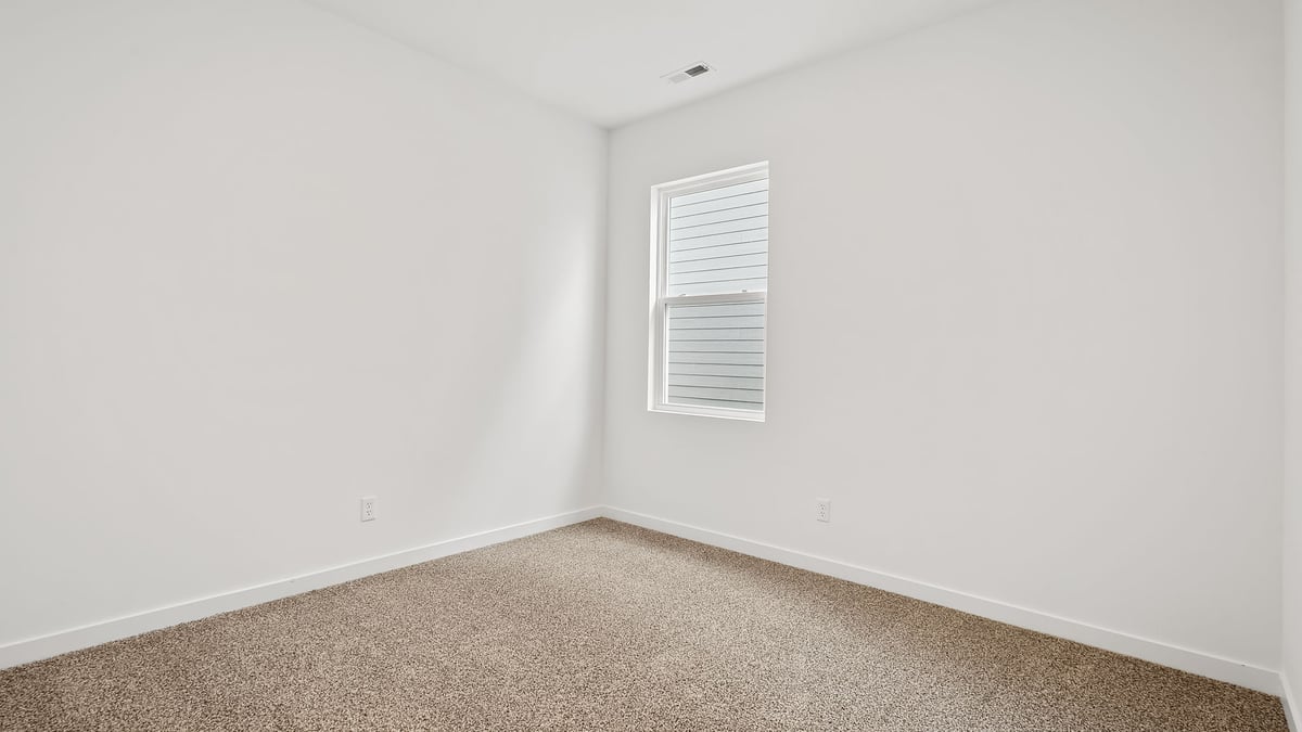 Bedroom with carpeted floors.