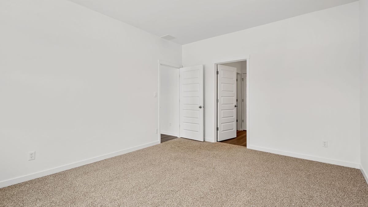 Bedroom with carpeted floors with a closet.