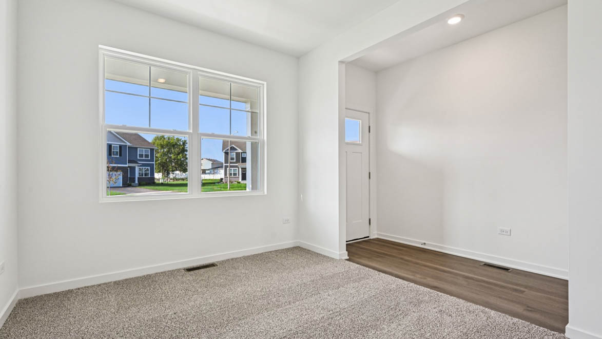 Front room with carpet and big window.