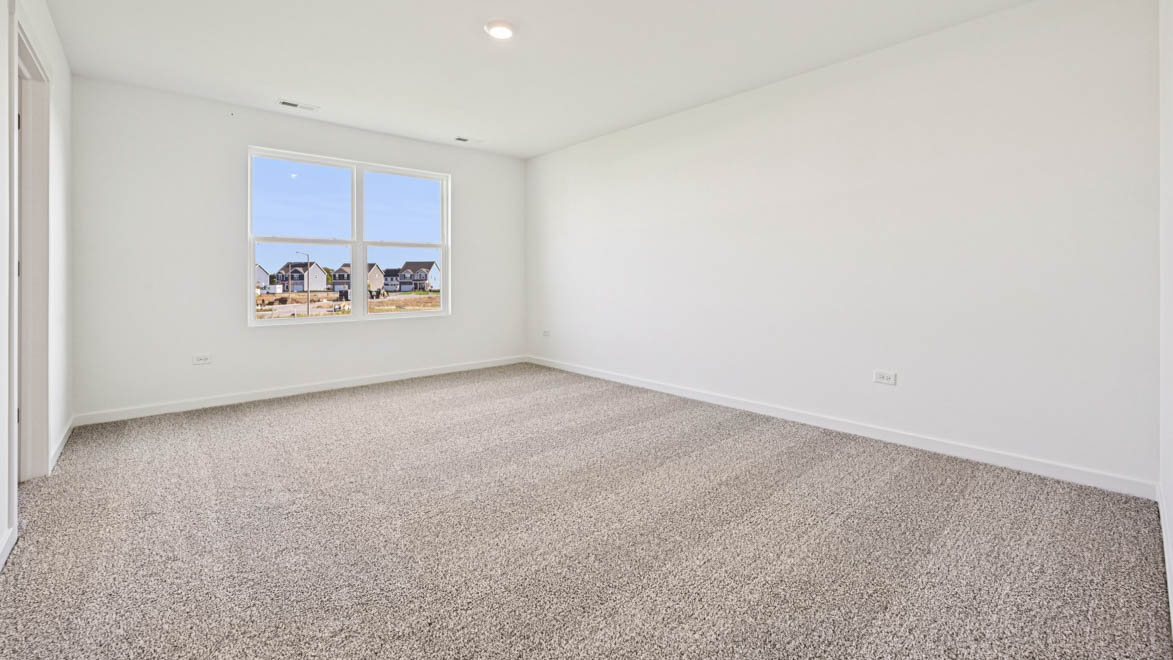 Bedroom with carpet and window.