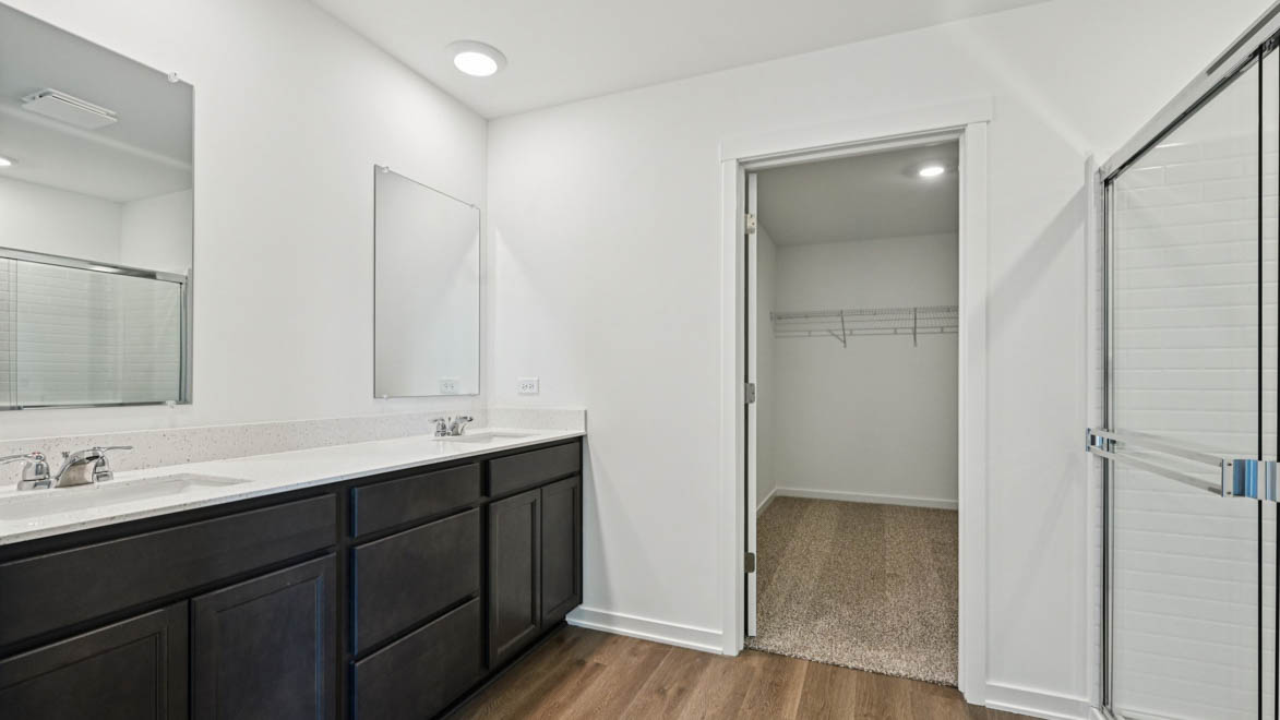 Dual vanity sinks with walk in closet.