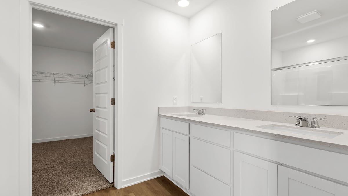 Dual vanity sink with walk in shower and walk in closet