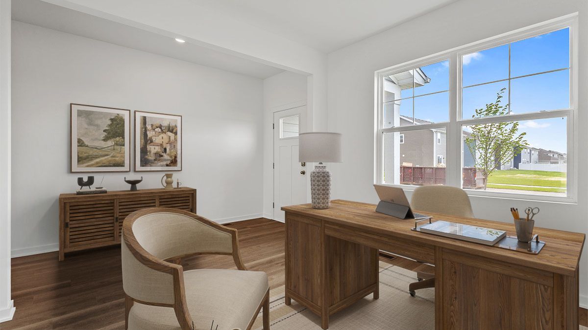 Front room with hard wood flooring and a big window.