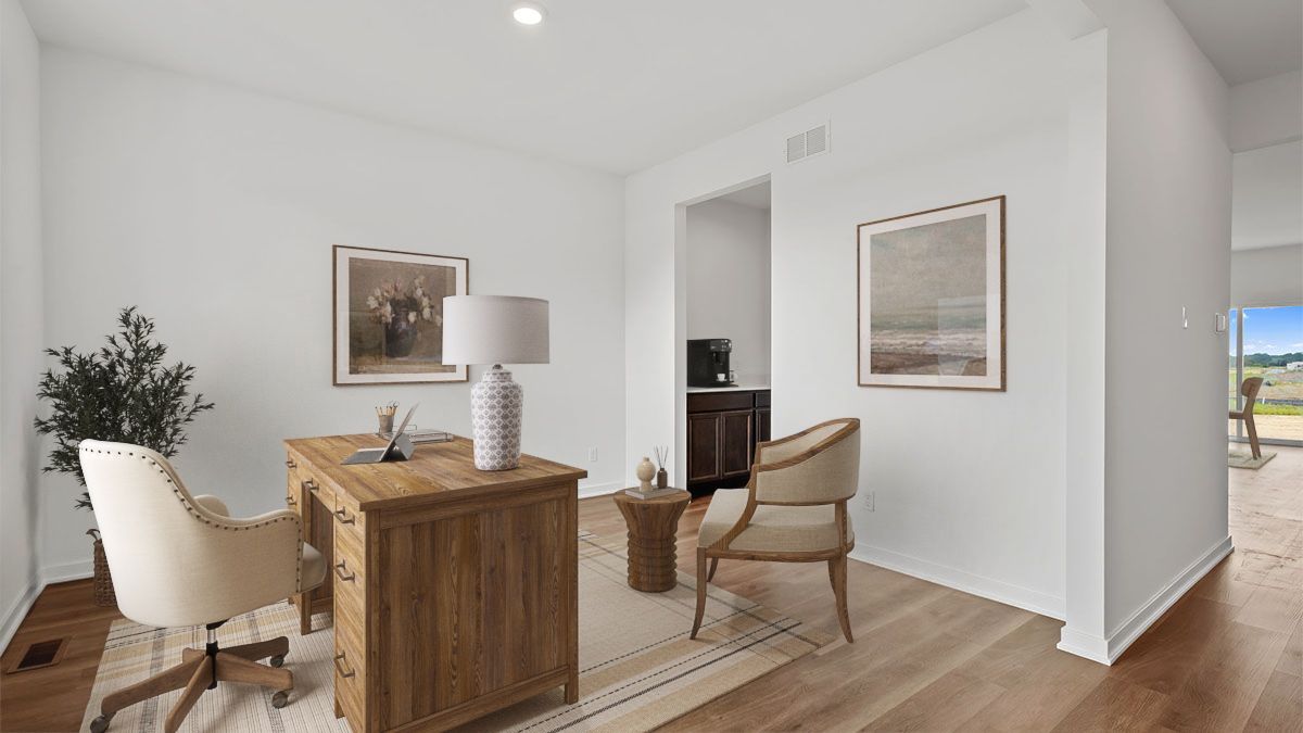 Front room with hard wood flooring and open space.