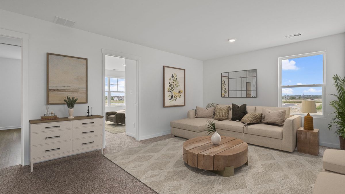 Upstairs loft area with carpeted floors.