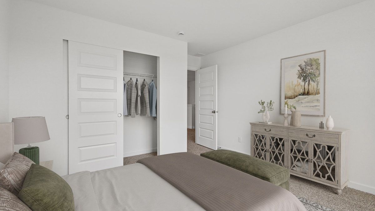 Bedroom with carpeted floors and a closet.