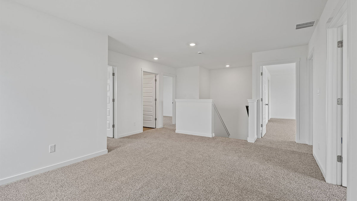 Loft area with carpeted floors.