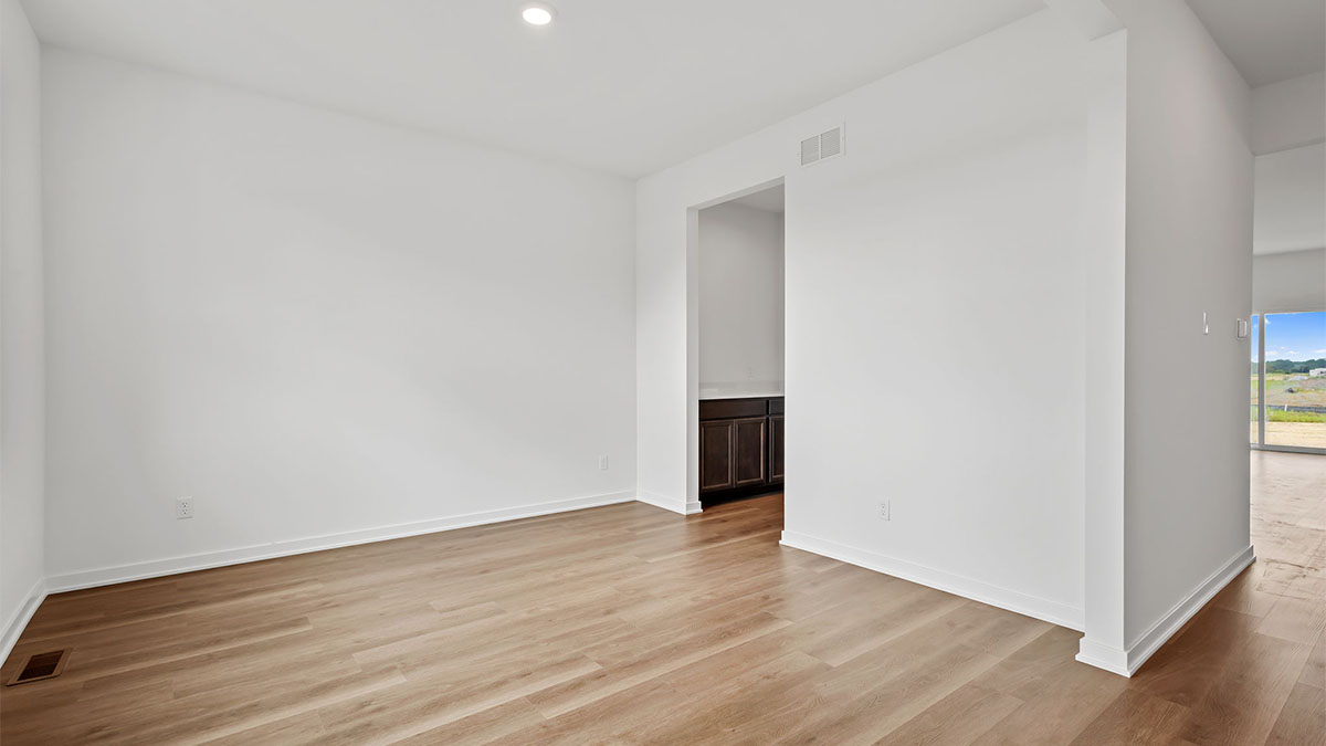 Front room with hard wood flooring and great space.
