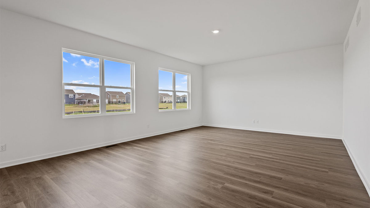 Living room area with plenty of space and two big windows.