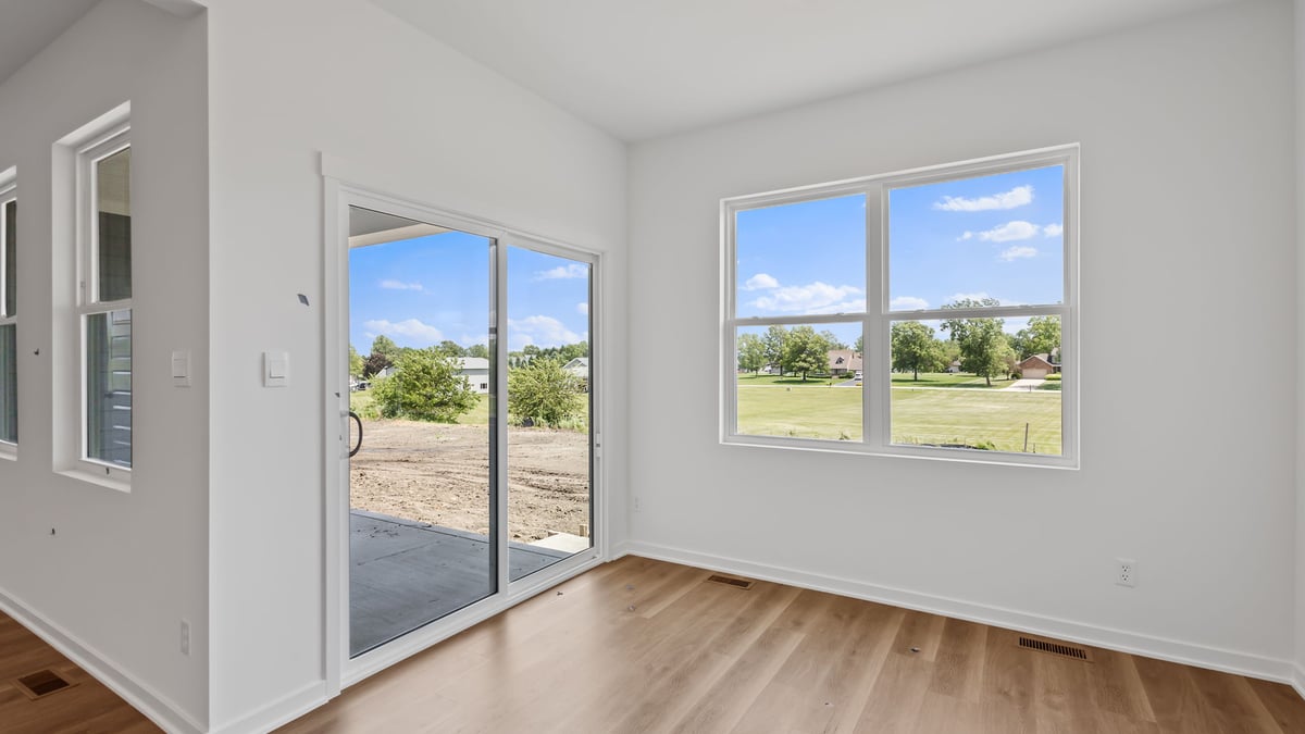 Dining area with glass sliding door with windows.