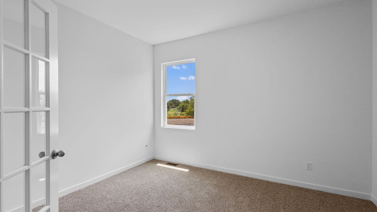 Bedroom with carpet and one window.